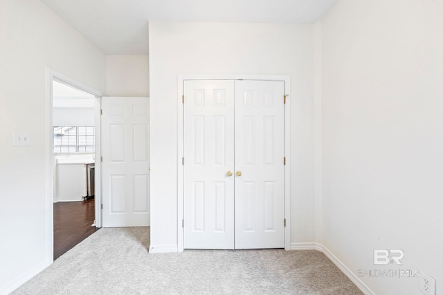 unfurnished bedroom featuring a closet and carpet floors