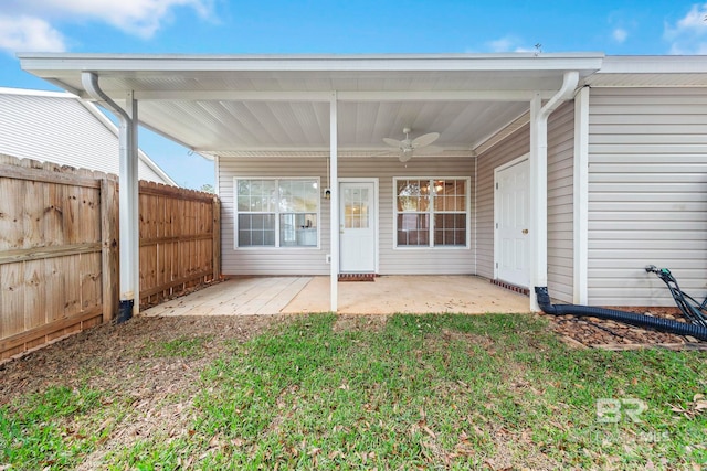 rear view of property featuring a patio area, a yard, and ceiling fan