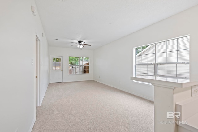 carpeted empty room with ceiling fan