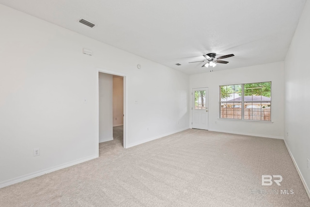 empty room featuring light carpet and ceiling fan