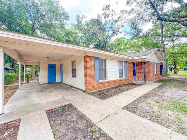 single story home featuring a carport