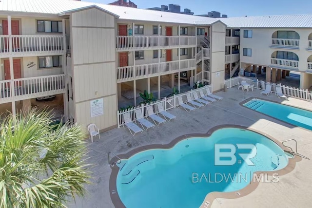 pool featuring a patio area and fence