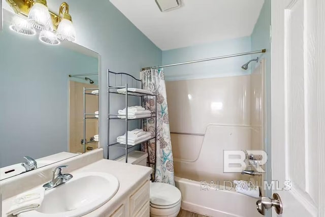 full bathroom with vanity, shower / bath combination with curtain, and toilet