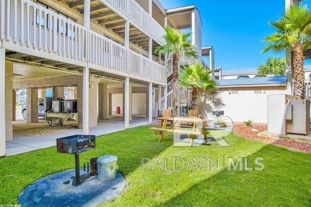 back of house featuring a yard and a patio area