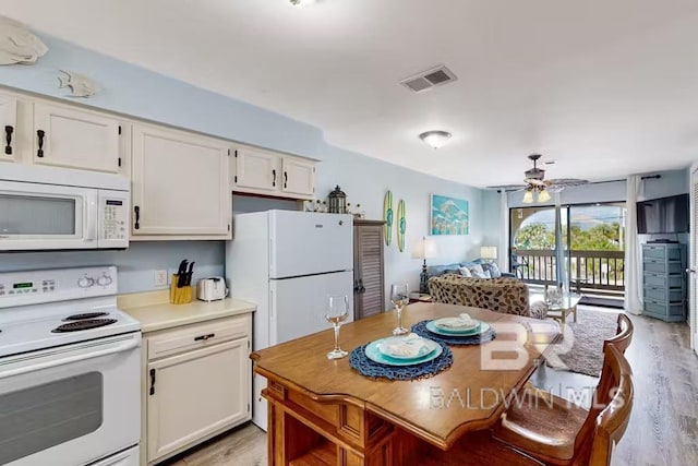 kitchen featuring white appliances, visible vents, light wood-style floors, white cabinets, and light countertops