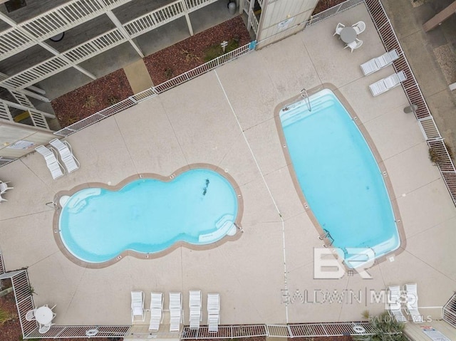 view of pool featuring fence