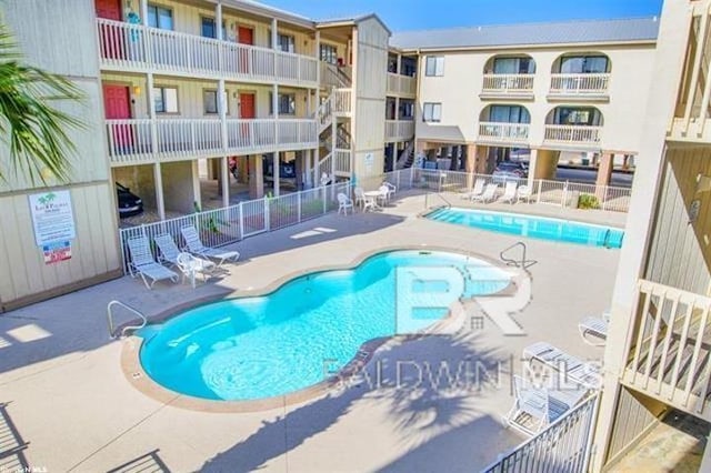 pool featuring a patio area and fence