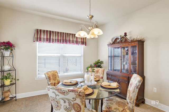 7091 Rocky Road Loop, Gulf Shores, AL 36542 - dining room featuring a chandelier, light tile patterned flooring, and baseboards