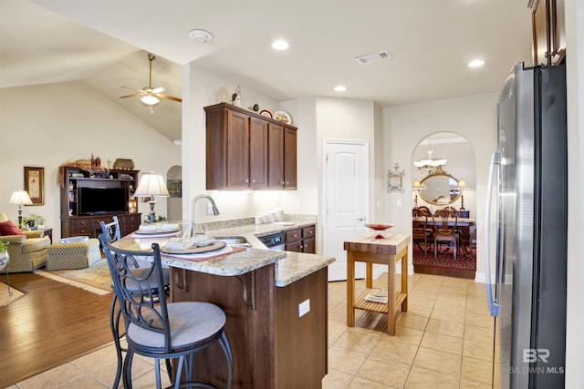 7091 Rocky Road Loop, Gulf Shores, AL 36542 - kitchen with a sink, a peninsula, freestanding refrigerator, visible vents, and open floor plan