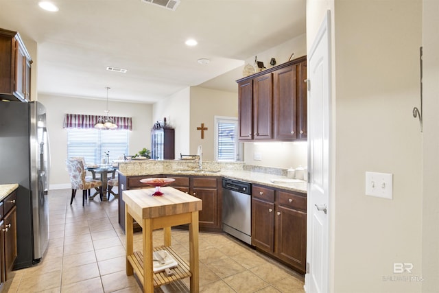 7091 Rocky Road Loop, Gulf Shores, AL 36542 - kitchen featuring a notable chandelier, pendant lighting, a sink, a peninsula, and appliances with stainless steel finishes