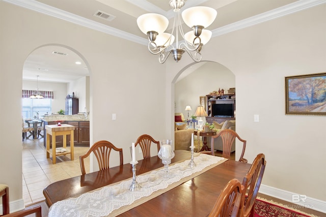 7091 Rocky Road Loop, Gulf Shores, AL 36542 - dining area with visible vents, arched walkways, and a notable chandelier
