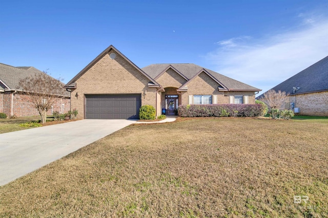 view of front of property with a garage and a front lawn