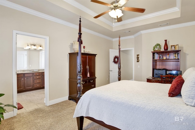 7091 Rocky Road Loop, Gulf Shores, AL 36542 - bedroom with light colored carpet, ensuite bath, crown molding, a raised ceiling, and baseboards
