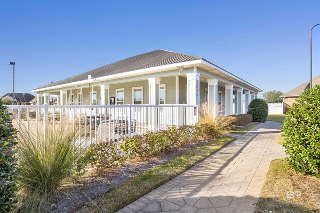7091 Rocky Road Loop, Gulf Shores, AL 36542 - view of side of property featuring metal roof and a porch