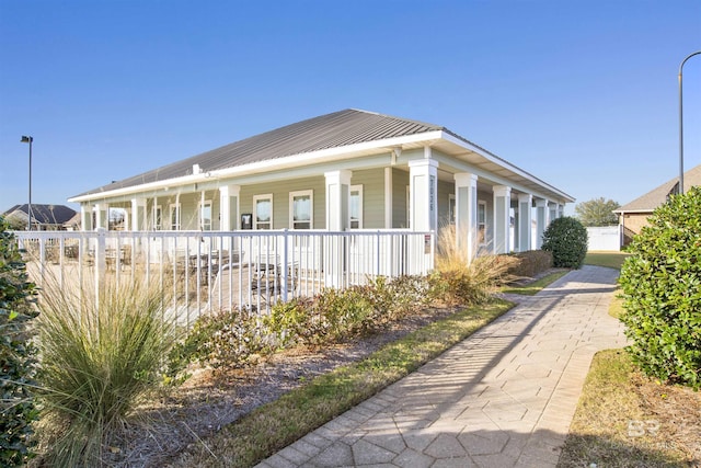 7091 Rocky Road Loop, Gulf Shores, AL 36542 - view of side of property featuring metal roof and a porch