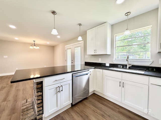 kitchen featuring stainless steel dishwasher, white cabinets, a sink, a peninsula, and dark wood-type flooring