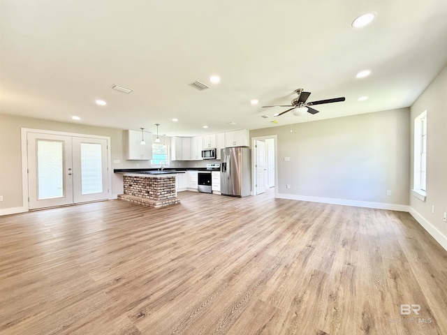 unfurnished living room with recessed lighting, light wood-type flooring, baseboards, visible vents, and a ceiling fan