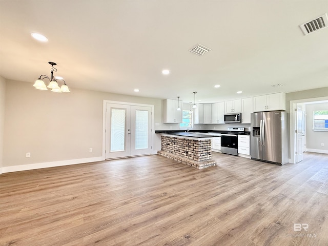 kitchen with baseboards, visible vents, dark countertops, and appliances with stainless steel finishes