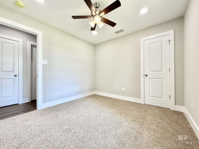 unfurnished bedroom featuring recessed lighting, carpet flooring, a ceiling fan, visible vents, and baseboards