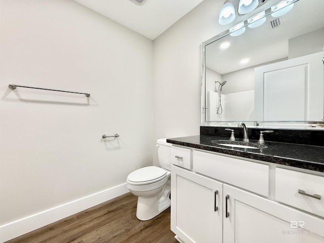 full bath with visible vents, baseboards, toilet, wood finished floors, and vanity