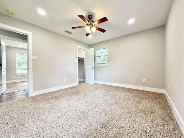 unfurnished bedroom with recessed lighting, a ceiling fan, visible vents, carpet, and baseboards