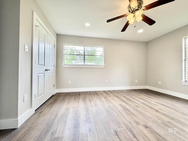spare room with baseboards, recessed lighting, wood finished floors, and ceiling fan