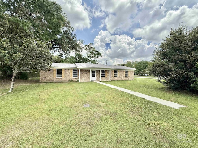 ranch-style house featuring a front yard and brick siding