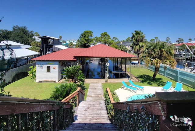 back of house featuring a yard and a water view