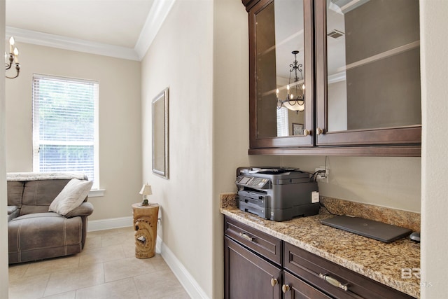 bar featuring baseboards, an inviting chandelier, ornamental molding, and light tile patterned floors
