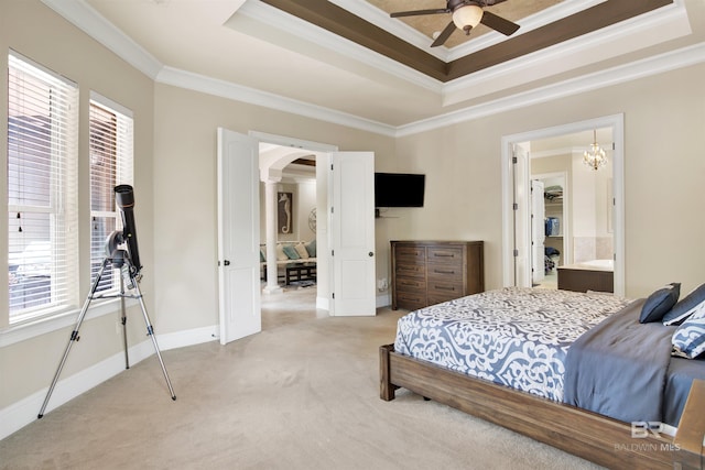 bedroom featuring crown molding, arched walkways, multiple windows, and a raised ceiling