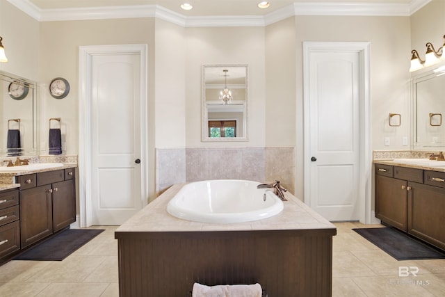 bathroom featuring crown molding, tile patterned flooring, a bath, and two vanities
