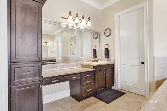 bathroom featuring crown molding, tile patterned floors, and vanity