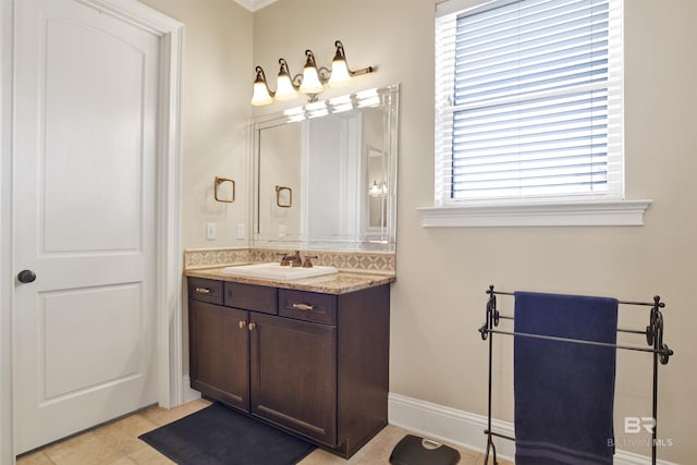 bathroom featuring vanity, tile patterned flooring, and baseboards