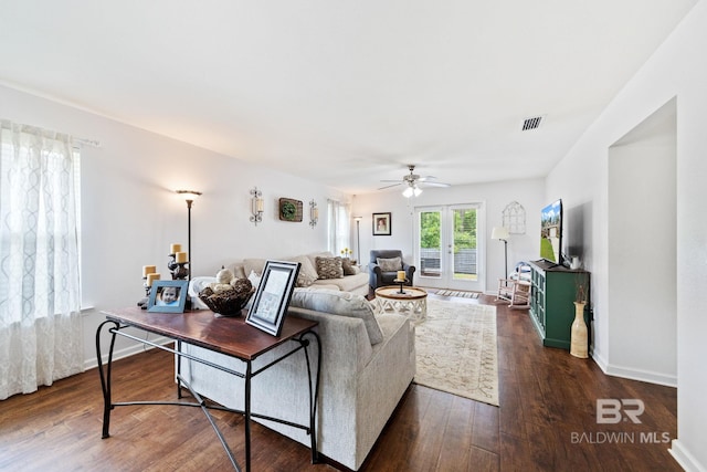 living room featuring dark hardwood / wood-style flooring, ceiling fan, and french doors