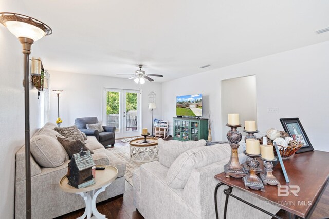 living room featuring hardwood / wood-style flooring and ceiling fan