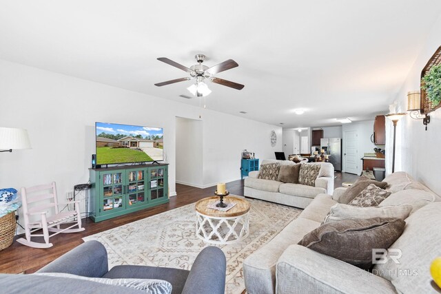 living room with ceiling fan and wood-type flooring