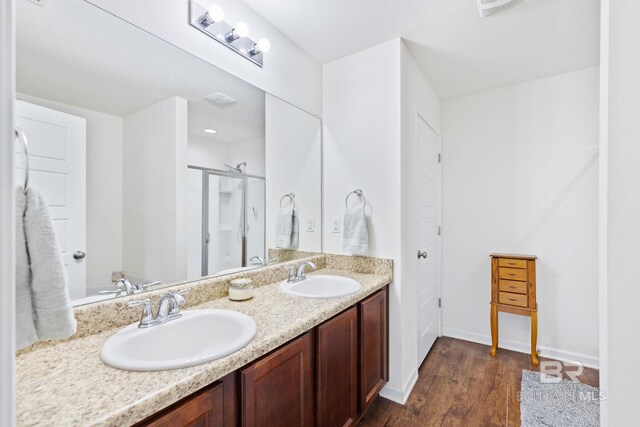 bathroom featuring dual vanity and wood-type flooring