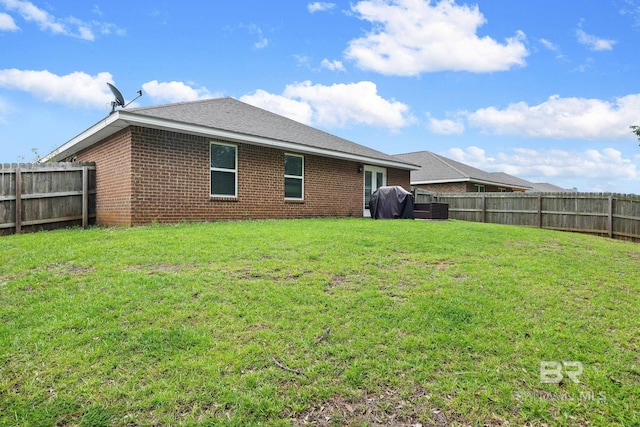 rear view of house featuring a lawn