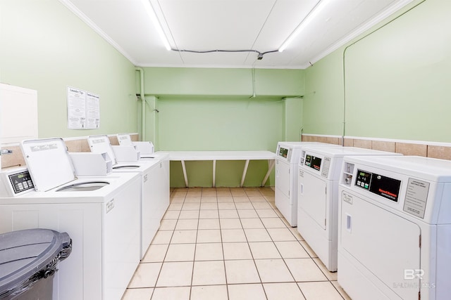 washroom with separate washer and dryer, crown molding, and light tile patterned flooring