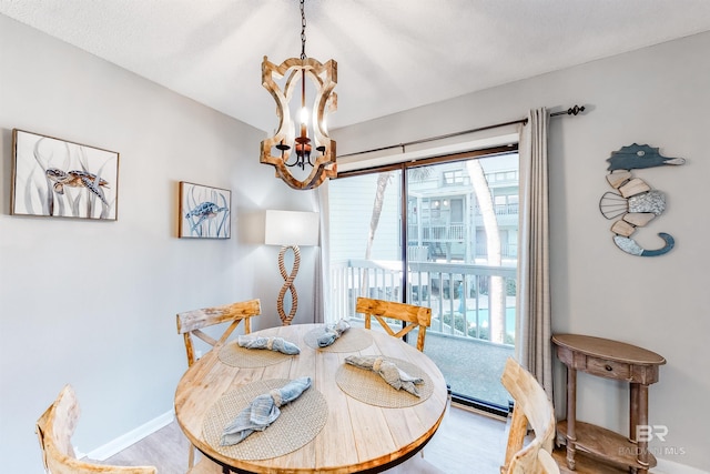 dining area featuring hardwood / wood-style floors, plenty of natural light, and a notable chandelier