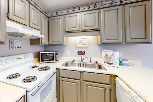 kitchen with a textured ceiling, gray cabinetry, sink, and white appliances