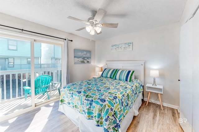 bedroom featuring access to exterior, ceiling fan, light hardwood / wood-style floors, and a textured ceiling