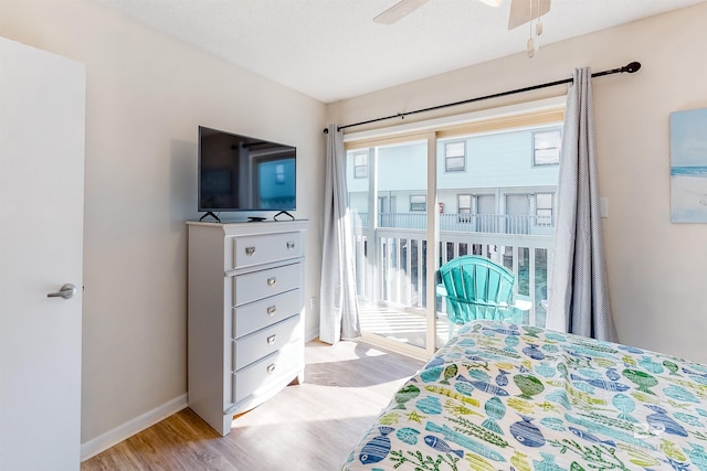 bedroom with ceiling fan, a textured ceiling, and light wood-type flooring