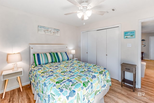 bedroom with ceiling fan, a closet, and light hardwood / wood-style flooring