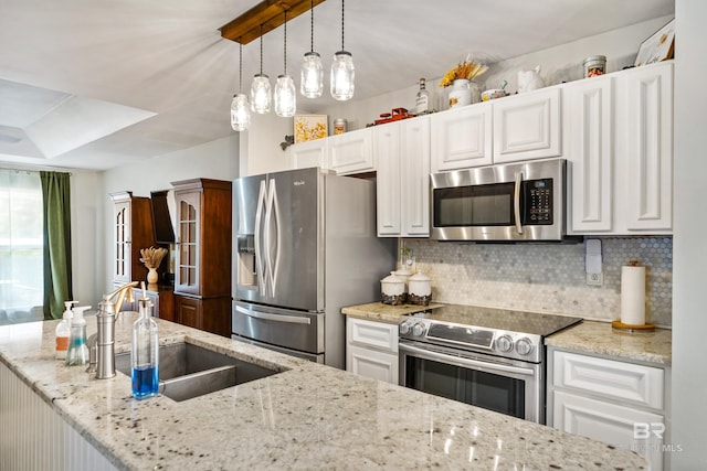 kitchen featuring white cabinetry, decorative backsplash, and stainless steel appliances