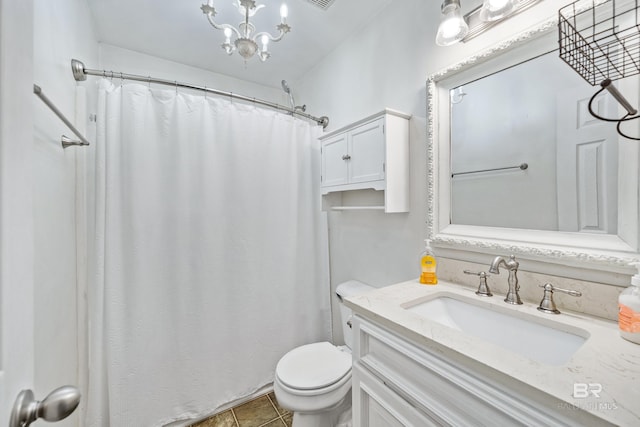 bathroom featuring tile patterned floors, toilet, vanity, a shower with shower curtain, and a notable chandelier