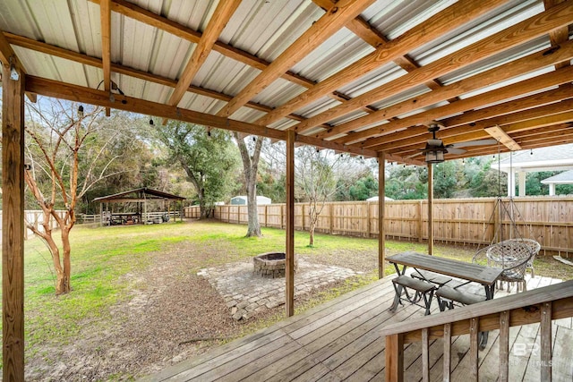 wooden terrace with a gazebo and a fire pit