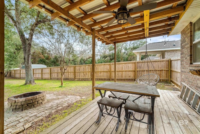 wooden terrace with a fire pit and ceiling fan