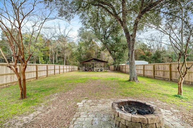 view of yard with a gazebo and a fire pit