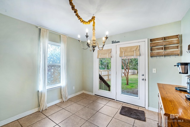 entryway featuring light tile patterned floors and a chandelier